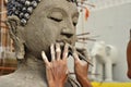 Artisan hands making clay buddha