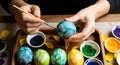 Artisan hands meticulously decorating a blue easter egg with intricate white patterns using a brush Royalty Free Stock Photo