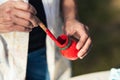 Artisan holding a brush and a pot with red paint outdoors Royalty Free Stock Photo