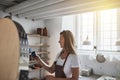 Artisan inspecting a glazed cup in her creative pottery studio Royalty Free Stock Photo