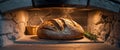Artisan loaf baking in a warm stone oven. Royalty Free Stock Photo