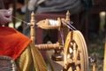 Artisan makes yarn with spinning wheel