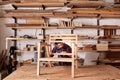 Artisan manufacturing a wooden chair frame in his studio Royalty Free Stock Photo