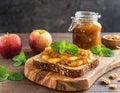 Artisan Multigrain Toast with Chunky Apple Preserve and Fresh Mint on a Carved Wooden Board