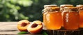 Artisan peach jam in glass jars with fresh ripe peaches on a rustic wooden table. Royalty Free Stock Photo