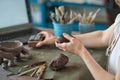 artisan pottery tutor in art studio. woman ceramist teaches an online lesson or leads a video master class on creating