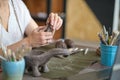 artisan pottery tutor in art studio. woman ceramist teaches an online lesson or leads a video master class on creating