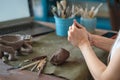 artisan pottery tutor in art studio. woman ceramist teaches an online lesson or leads a video master class on creating