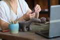 artisan pottery tutor in art studio. woman ceramist teaches an online lesson or leads a video master class on creating