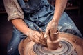 Artisan sculptor works with clay on a Potter& x27;s wheel and at the table with the tools. Ceramics art concept. Close-up