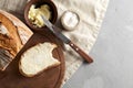 Artisan sliced toast bread with butter and sugar on wooden cutting board. Simple breakfast on grey concrete background Royalty Free Stock Photo