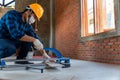 Artisan tiler, Industrial tiler builder worker working with floor tile cutting equipment at construction site Royalty Free Stock Photo