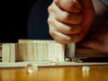 artisan violin maker luthier working with violin mould for center bot, carving corner blocks