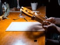 artisan violin maker luthier working with violin mould for center bot, corner blocks , bend ribs for new violin