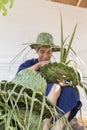 Artisan weaving palm leaf for making hat
