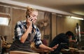 Artisan woman talking the phone in carpentry workshop Royalty Free Stock Photo