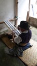 Artisan working on a backstrap loom in an artisanal shop