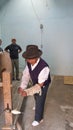 Artisan working on a wooden spinning wheel in an artisanal shop