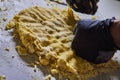 Artisanal Dough Kneading with Gloved Hands, Counter View