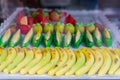 Artisanal marzipan figures. bananas, corns and some fruits like apricots or peaches marzipan shapes for dessert.