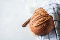 Artisanal sourdough bread with glass of milk on a gray background. Close up