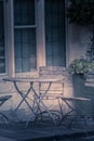 Artisitc metal table and chair in a garden UK