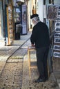 Artist in the alley of shops and art galleries in Tzfat Royalty Free Stock Photo