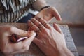 Artist applying henna tattoo on women hands. Royalty Free Stock Photo