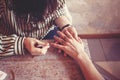 Artist applying henna tattoo on women hands. Royalty Free Stock Photo