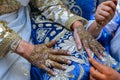 Artist applying henna tattoo on women hands. Mehndi is traditional moroccan decorative art. Royalty Free Stock Photo