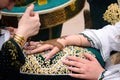 Artist applying henna tattoo on women hands. Mehndi is traditional moroccan decorative art Royalty Free Stock Photo