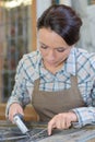 Artist applying lead to glass