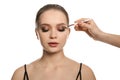 Artist applying makeup onto woman`s face on background Royalty Free Stock Photo