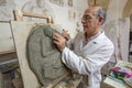 Artist in the art studio at work on a clay sculpture