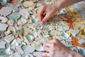 artist assembling broken china into a mosaic Royalty Free Stock Photo