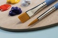 Artist brushes and paint on a wooden palette Royalty Free Stock Photo