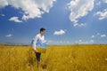 Artist with canvas in hand on a field