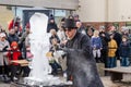 An artist carves ice with a chainsaw in a demonstration at the Fire and Ice Festival in Durham UK