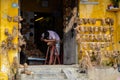 Artist carving human heads made of wooden roots