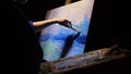 Artist copyist paint seascape with ship in ocean. Craftsman decorator draw as boat sail on blue sea with acrylic oil Royalty Free Stock Photo