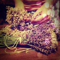 Artist creating lavander bunch. Wooden table with lavender