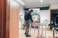 Artist in a dark sweater and hats for work in the studio, a man puts an unfinished picture into an easel and will continue to draw