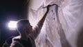 Artist designer draws an eagle on the wall. Craftsman decorator paints picture with acrylic oil color. Painter painter