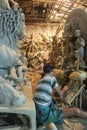 Artist doing a fine retouching job on a Clay idols of hindu godess at Kumartuli,Kolkata,India