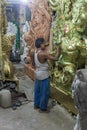 Artist doing a fine retouching job on a Clay idols of hindu godess at Kumartuli Workshop,Kolkata,India