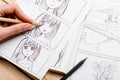 Artist drawing an anime comic book in a studio