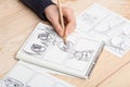 Artist drawing an anime comic book in a studio