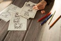 Artist drawing an anime comic book in a studio. Wooden desk, natural light