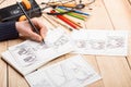 Artist drawing an anime comic book in a studio. Wooden desk, natural light. Creativity and inspiration concept