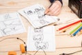 Artist drawing an anime comic book in a studio. Wooden desk, natural light. Creativity and inspiration concept Royalty Free Stock Photo